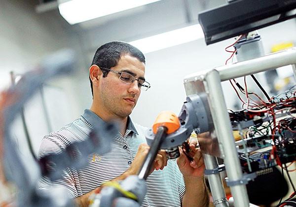 Sal Rojas working on a robot